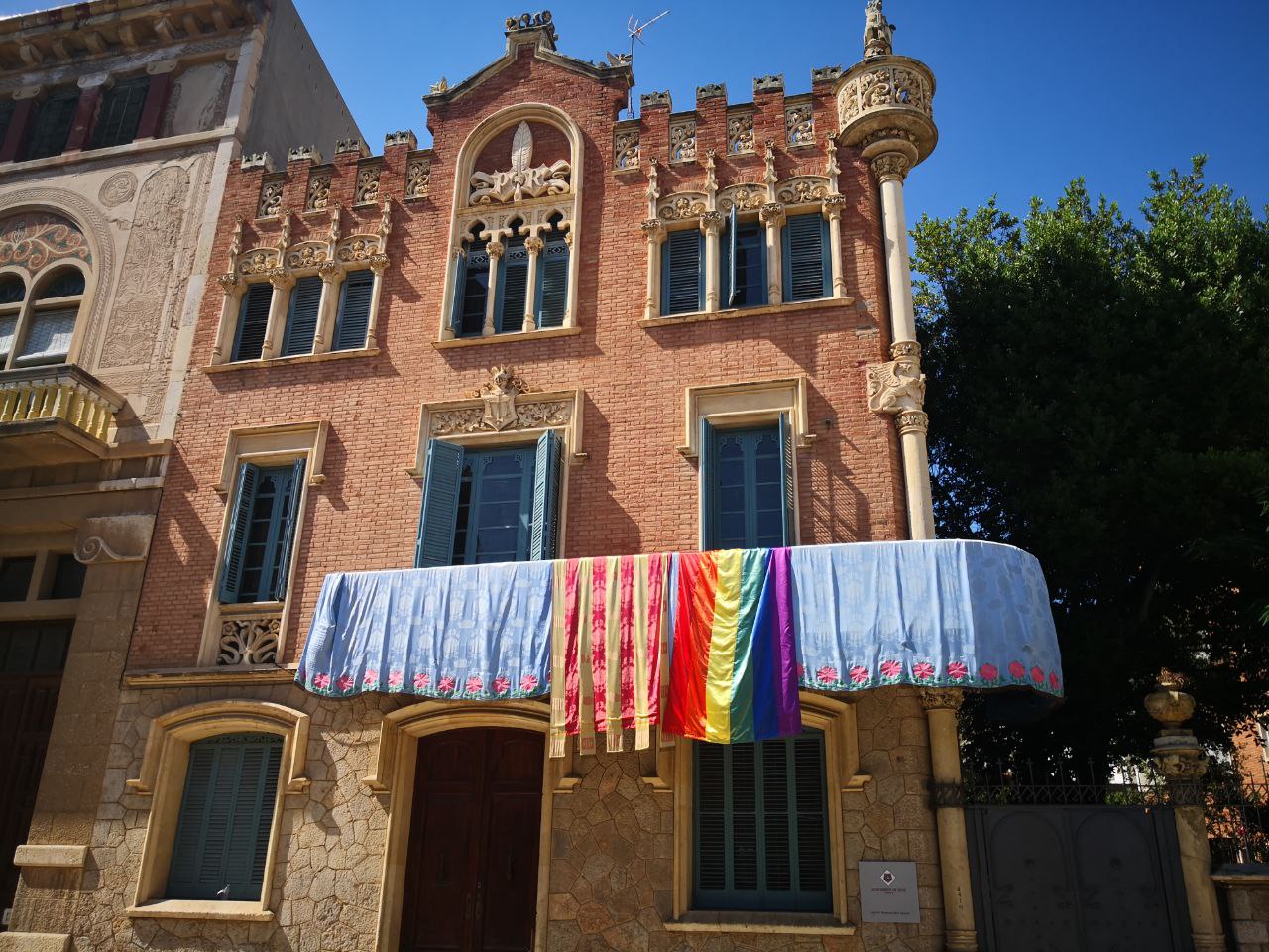 La bandera de l'arc de Sant Martí oneja al balcó de la Casa Rull